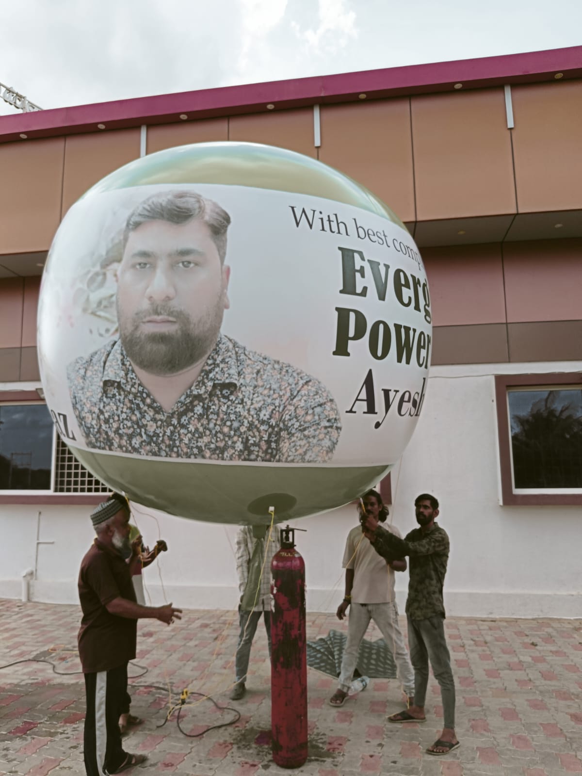 Custom photo-printed advertising sky balloon inflated with helium at a venue entrance