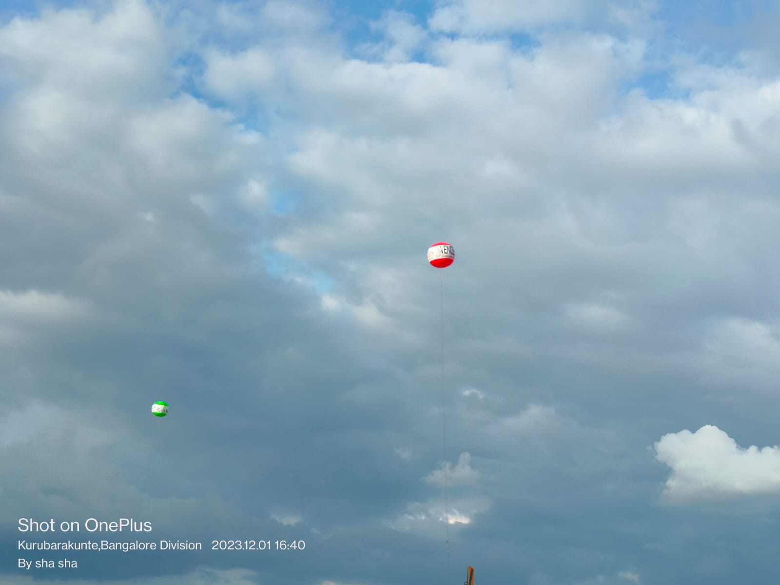 Two advertising sky balloons flying high above a Bangalore project site